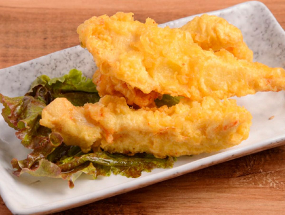 大分名物とり天を揚げて皿に盛り付け、かぼすとタレを添えた画像。外はサクサク、中はジューシーな大分のご当地グルメを自宅で簡単に楽しめる。